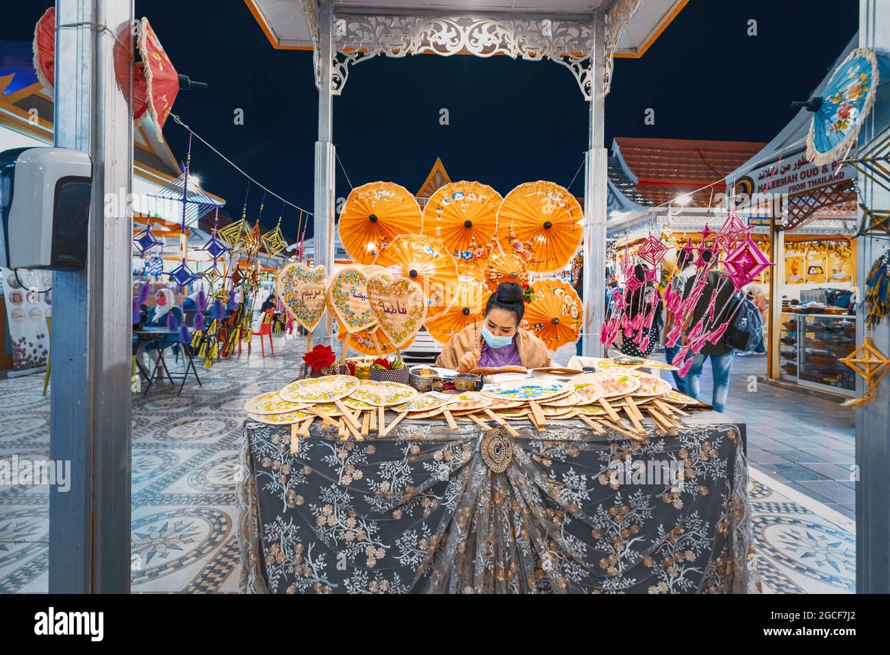 26 February 2021, UAE, Dubai A female craftsman paints bright