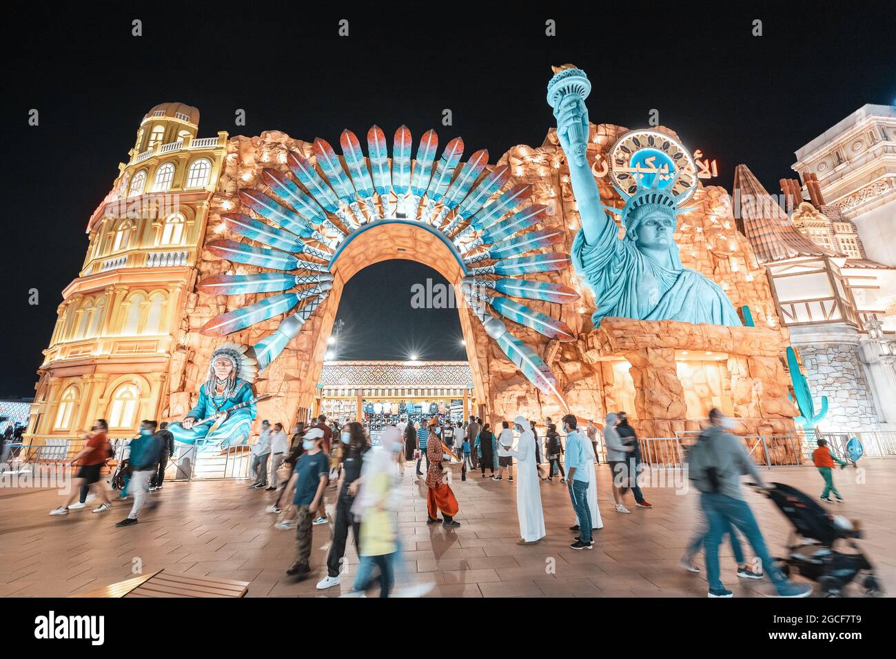 26 February 2021, UAE, Dubai: Crowd of tourists near pavilion in the global village dedicated to the culture and traditions of North America Stock Photo