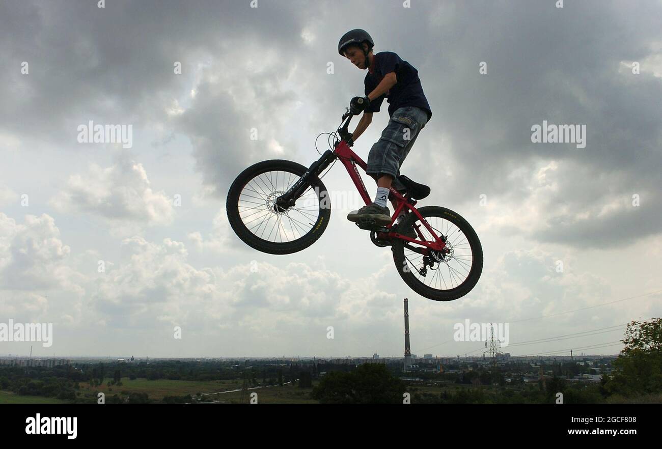 Young boys doing dare devil bicycle stunts in woodland near Budapest in Hungary 2006 Stock Photo