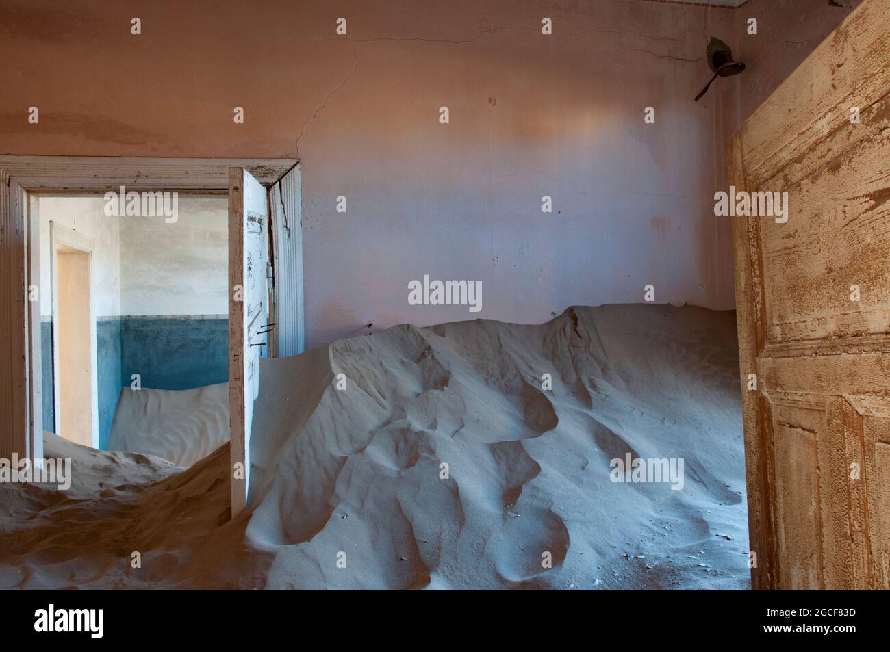 Interior room in Kolmanskop, a ghost mining town in Namibia, Africa. The desert has reclaimed the town after it was abandoned. Stock Photo