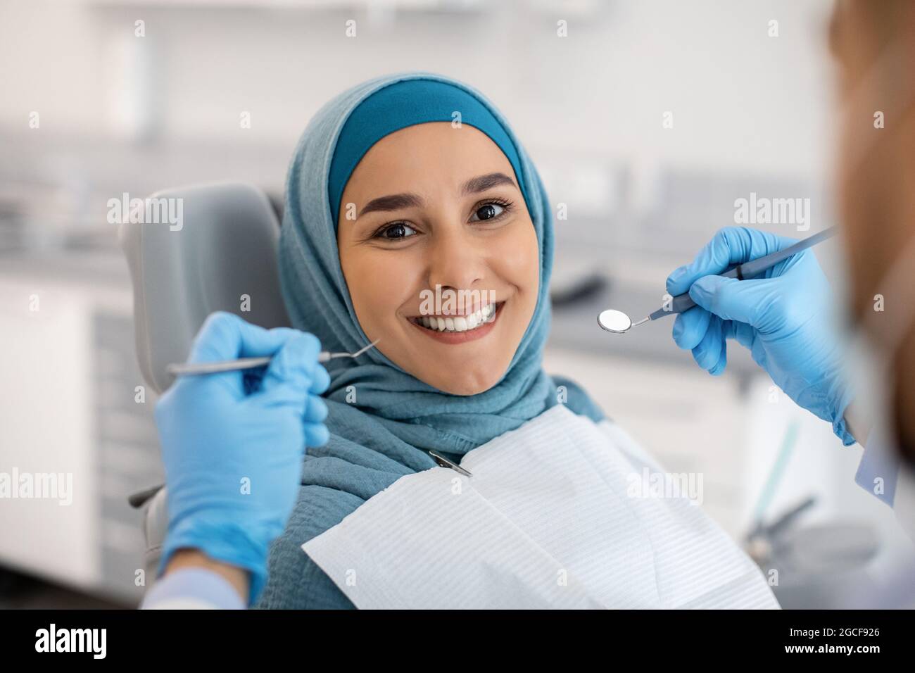 Portrait Of Happy Muslim Woman Sitting At Dentist Chair In Modern
