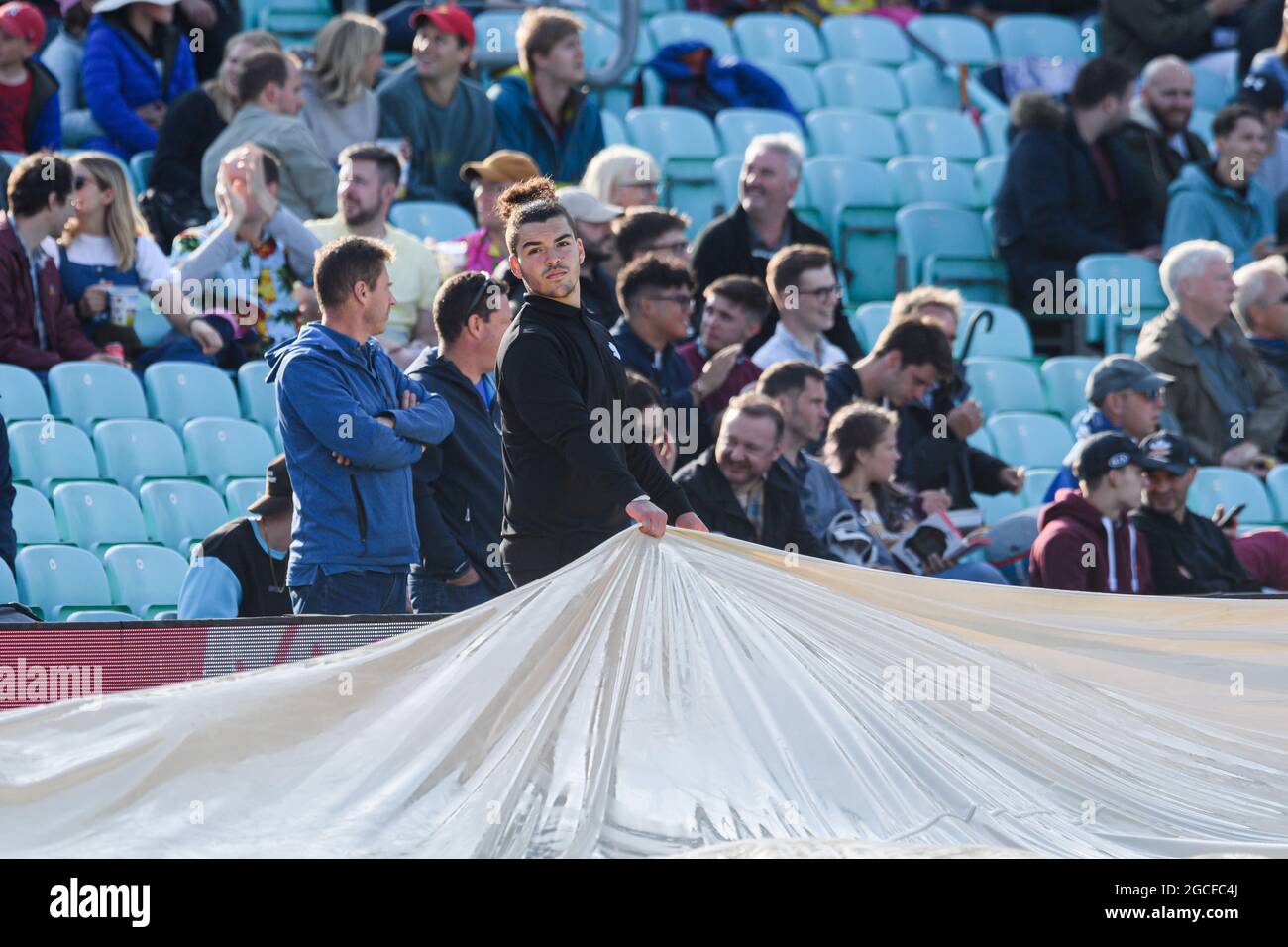LONDON, UNITED KINGDOM. 08th Aug, 2021. The workers try to cover the ground while rain started during The Hundred between Oval Invincibles vs Trent Rockers at The Oval Cricket Ground on Sunday, August 08, 2021 in LONDON ENGLAND.  Credit: Taka G Wu/Alamy Live News Stock Photo