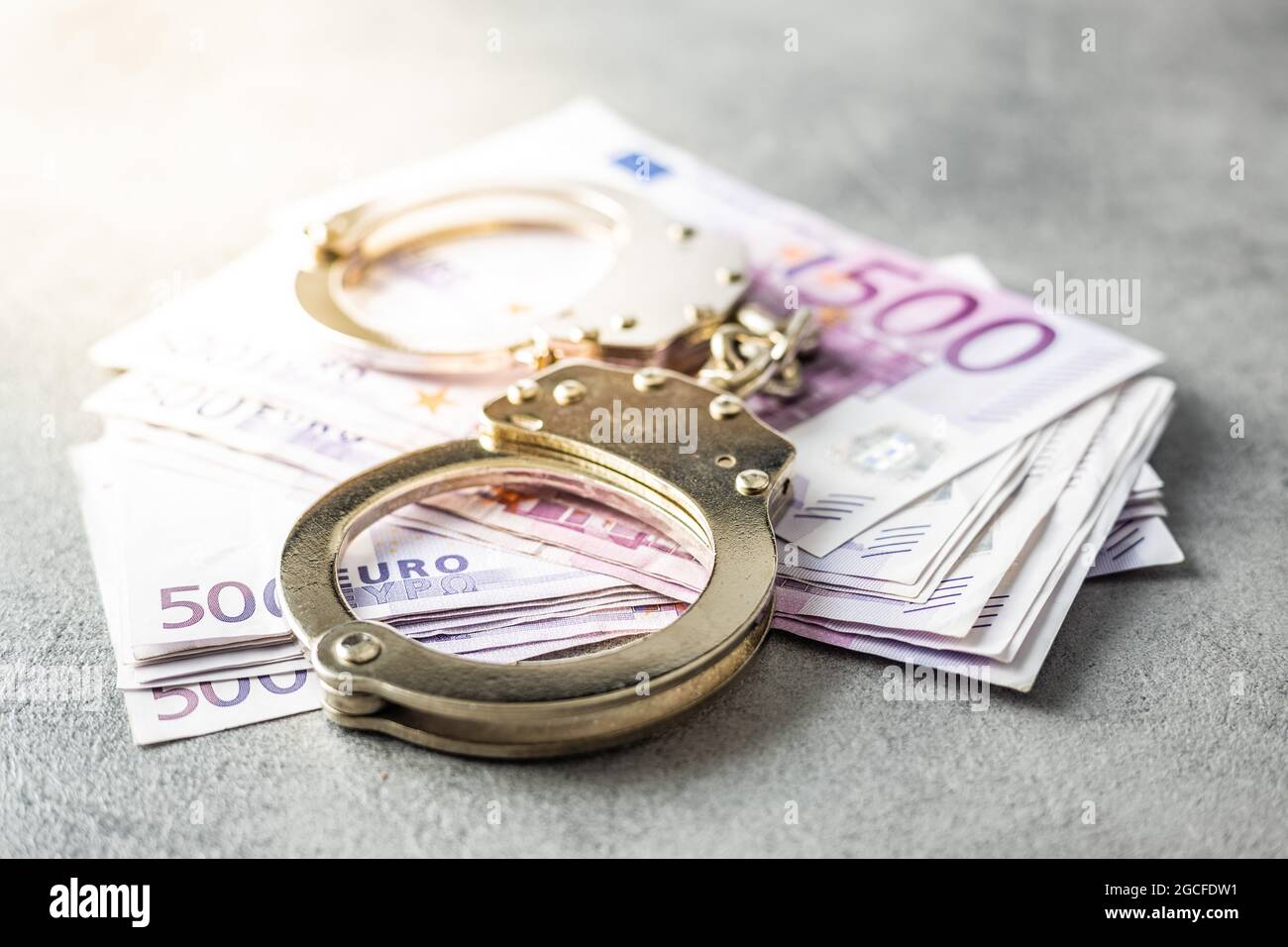 Euro banknotes and handcuffs. Stock Photo