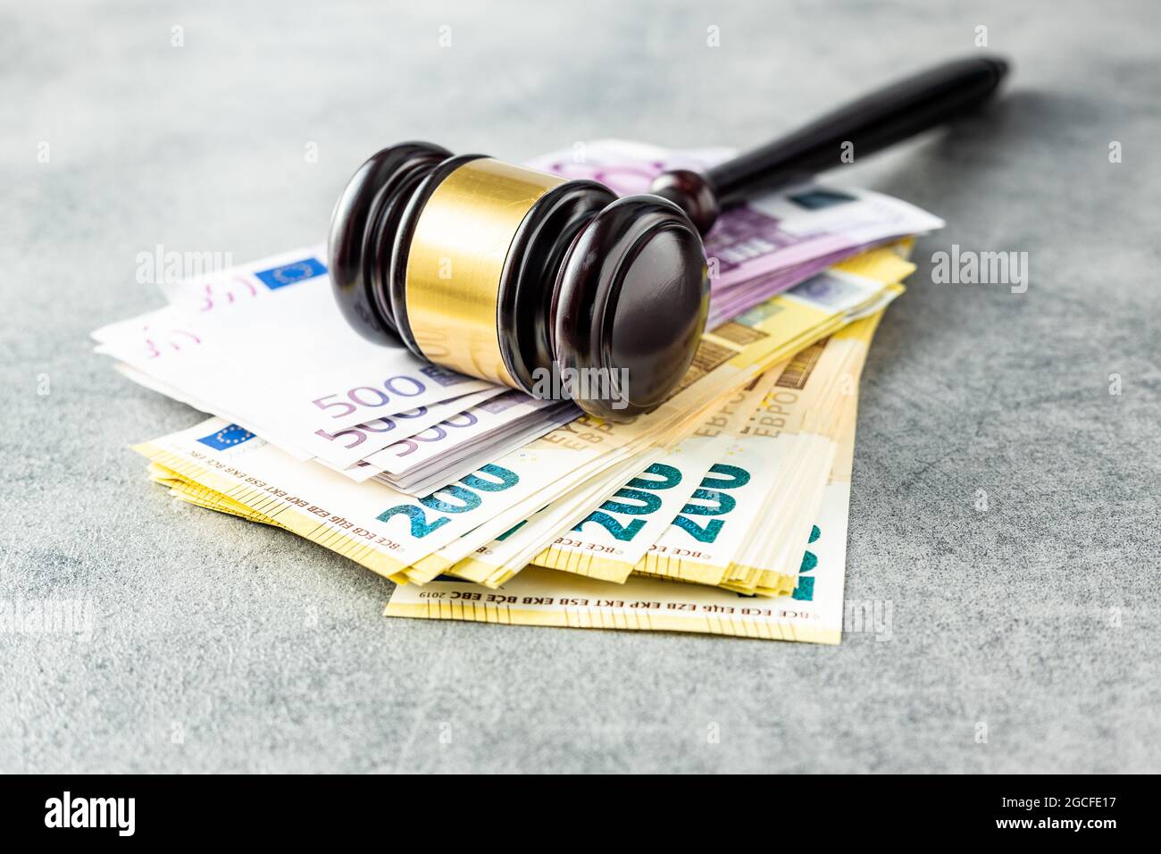 Euro banknotes and judge gavel on rusty table. Stock Photo