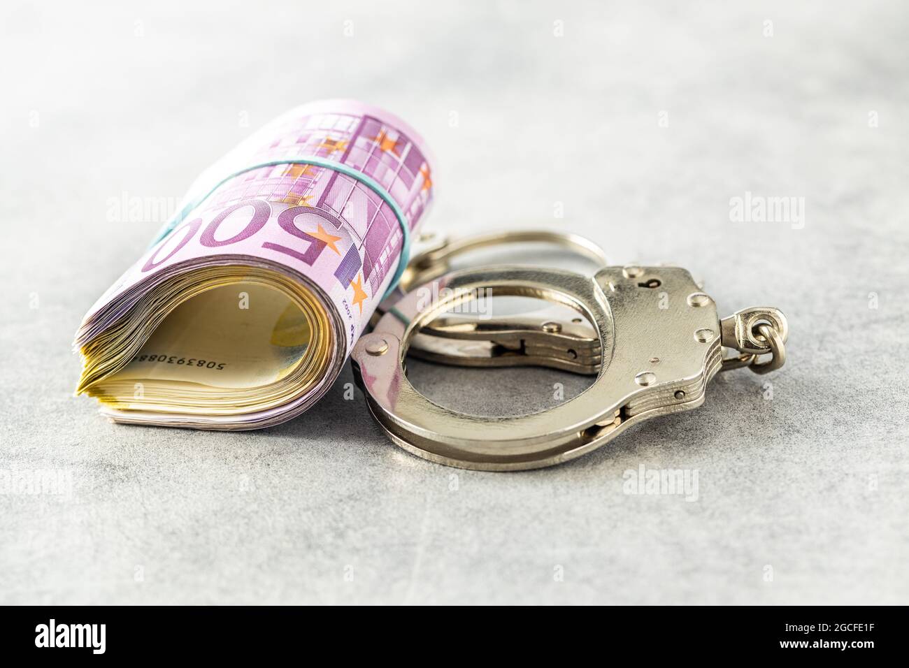 Euro banknotes and handcuffs. Stock Photo