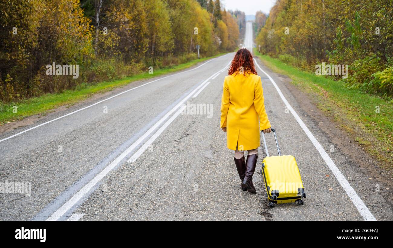 Red haired woman traveler walks hi-res stock photography and images - Alamy