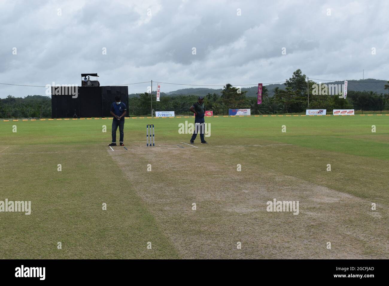 Ground staff getting ready the picturesque Army Ordinance cricket grounds for a match. Dombagoda. Sri Lanka. Stock Photo