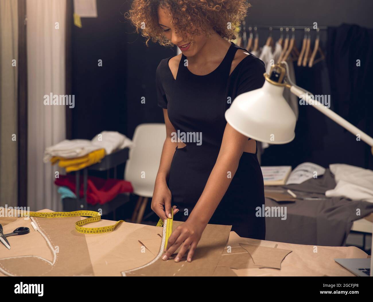 A young fashion designer working on her atelier Stock Photo - Alamy