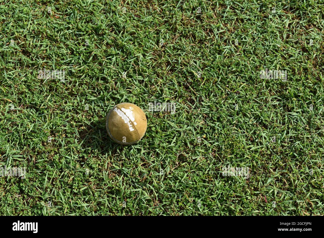 A used cricket ball lying on the ground. Sri Lanka. Stock Photo