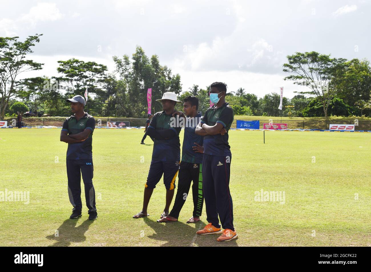 Ground staff getting ready the picturesque Army Ordinance cricket grounds for a match. Dombagoda. Sri Lanka. Stock Photo
