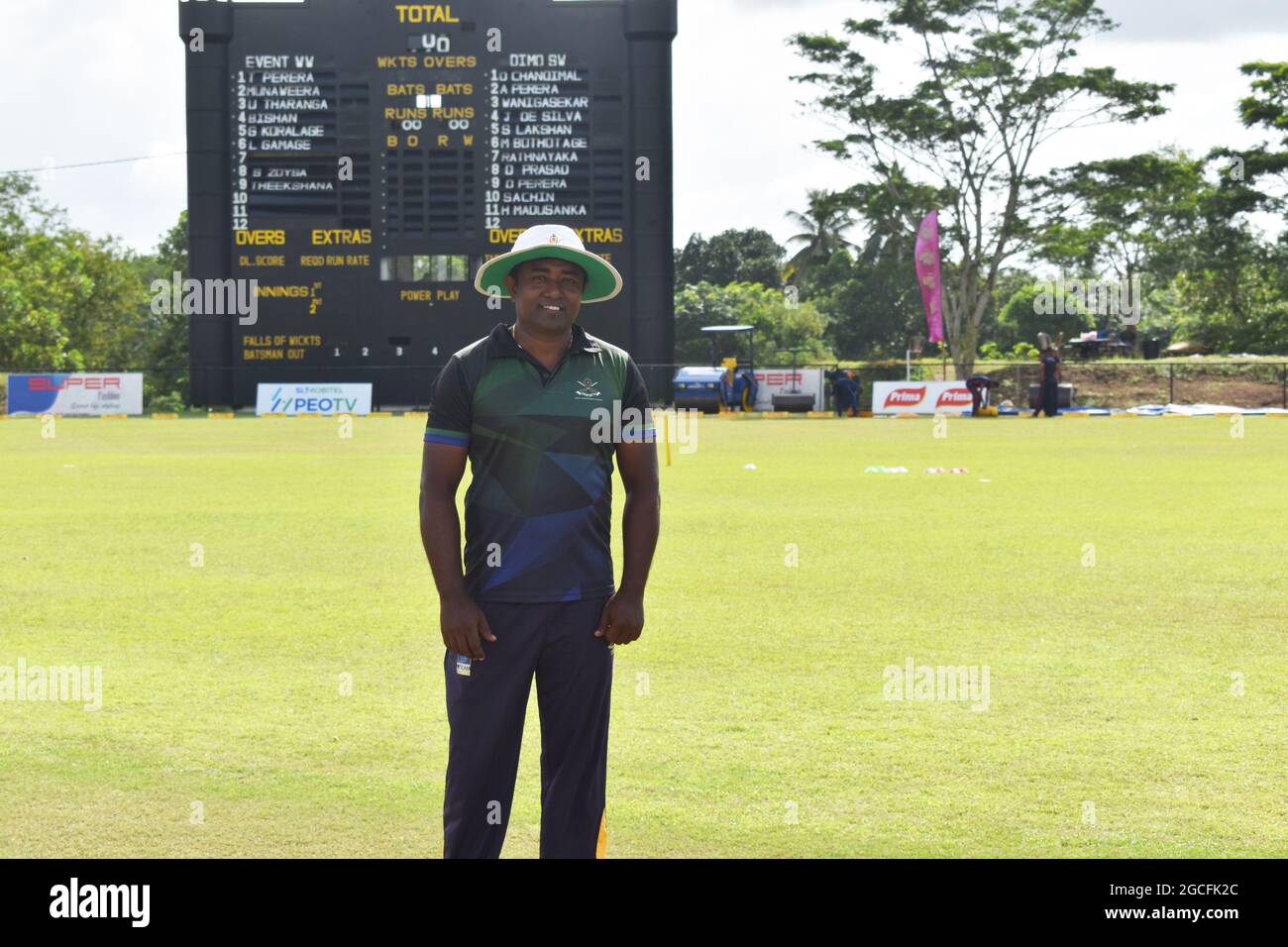 Ground staff at the picturesque Army Ordinance cricket grounds. Dombagoda. Sri Lanka. Stock Photo