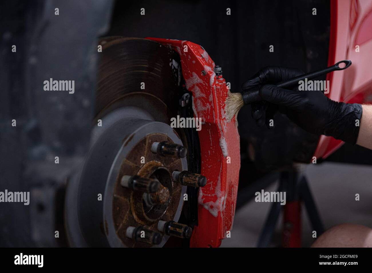 Man detailing studio worker cleaning brake caliper Stock Photo Alamy