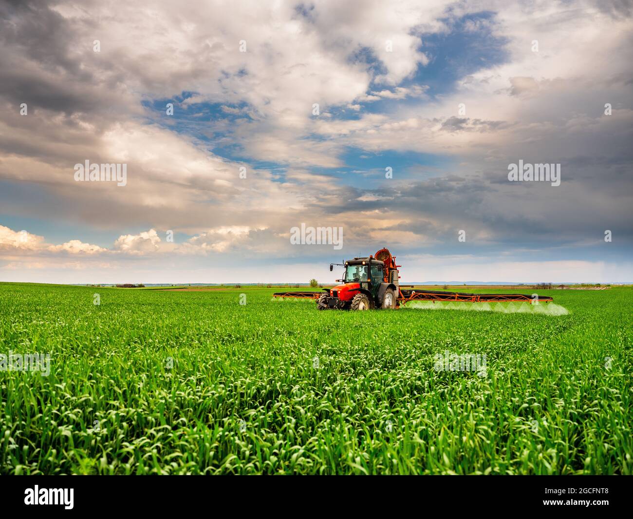 Farmer spraying wheat crops Stock Photo - Alamy