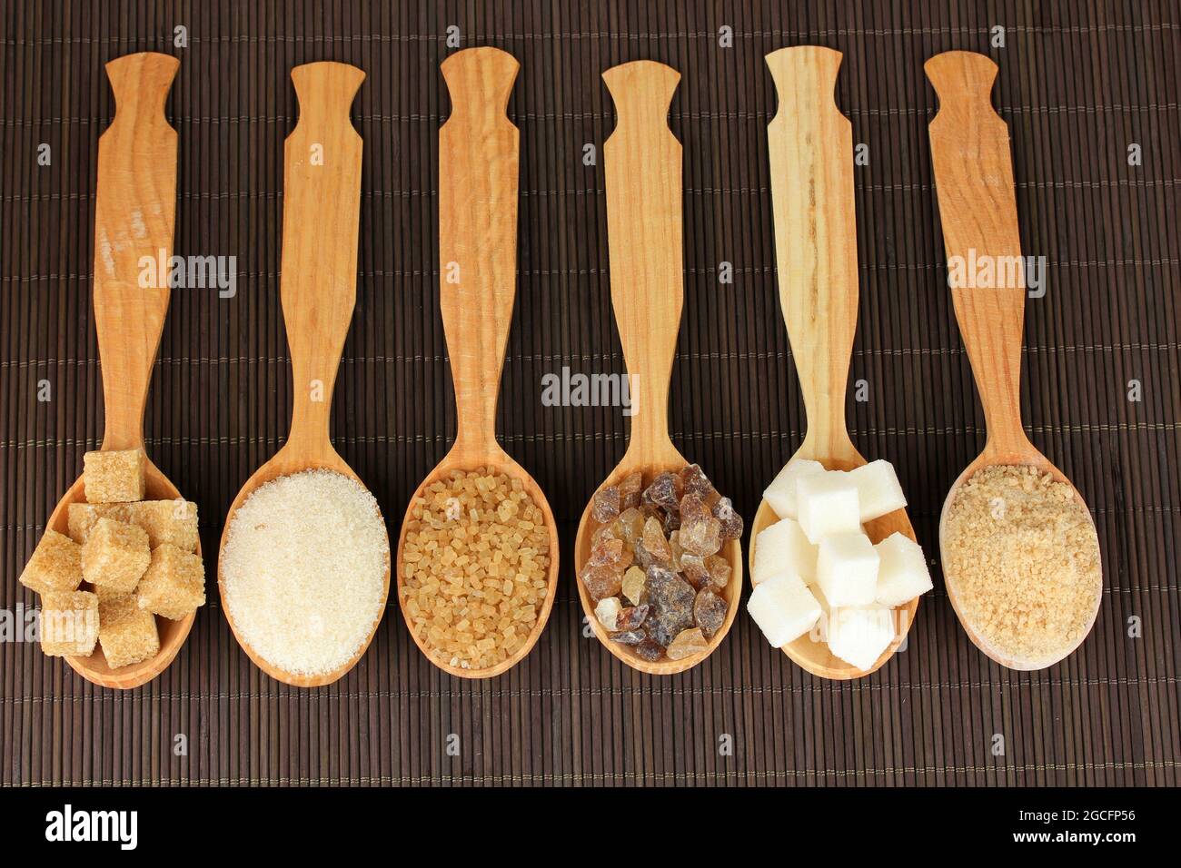 Different types of sugar in spoons on table closeup Stock Photo Alamy