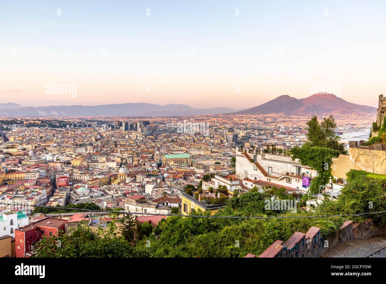 Napoli, Italy - July 11, 2021: Bay of Napoli and Vesuvius volcano in background at sunset in a summer day in Italy, Campania Stock Photo