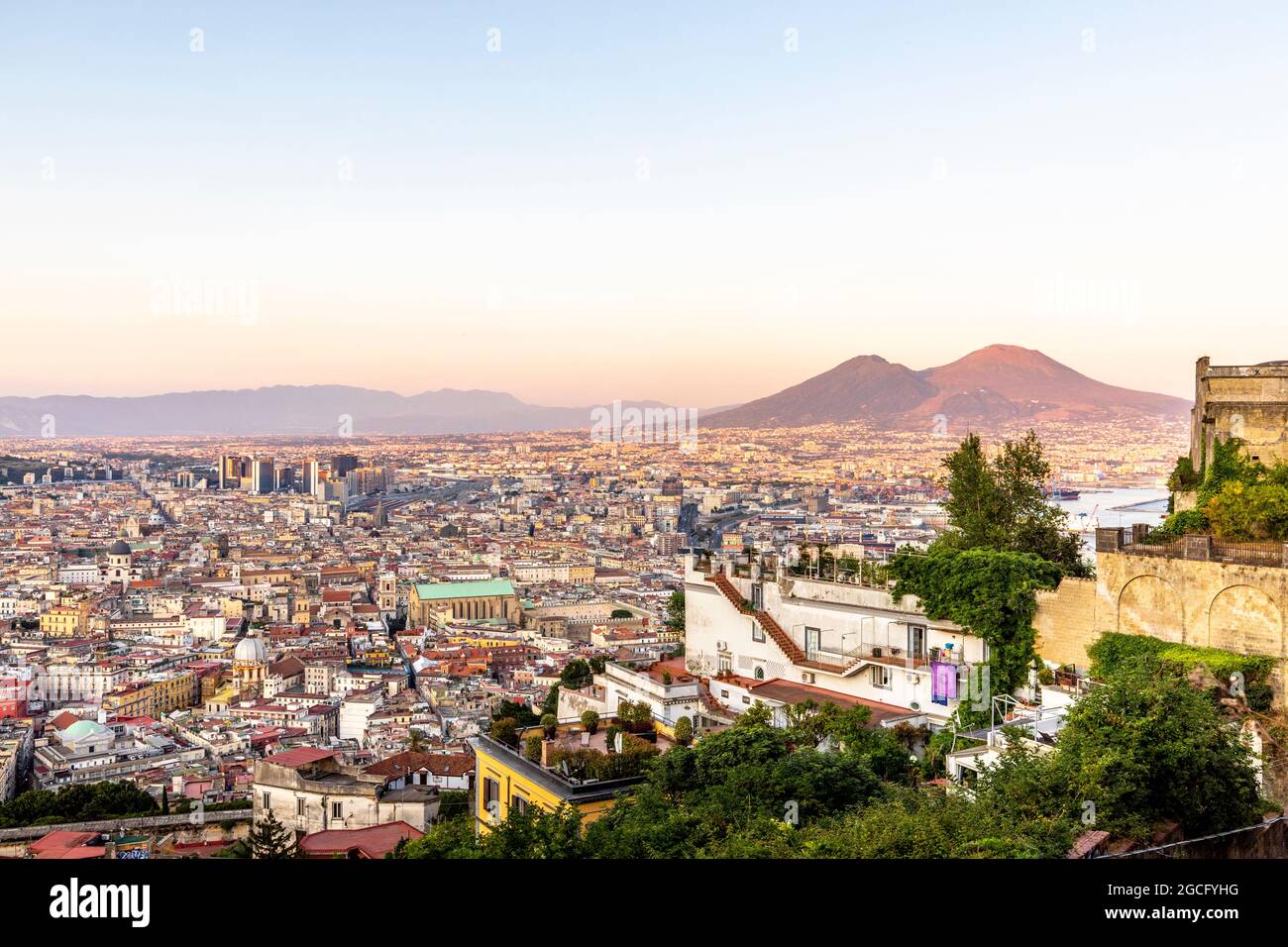 Napoli, Italy - July 11, 2021: Bay of Napoli and Vesuvius volcano in background at sunset in a summer day in Italy, Campania Stock Photo