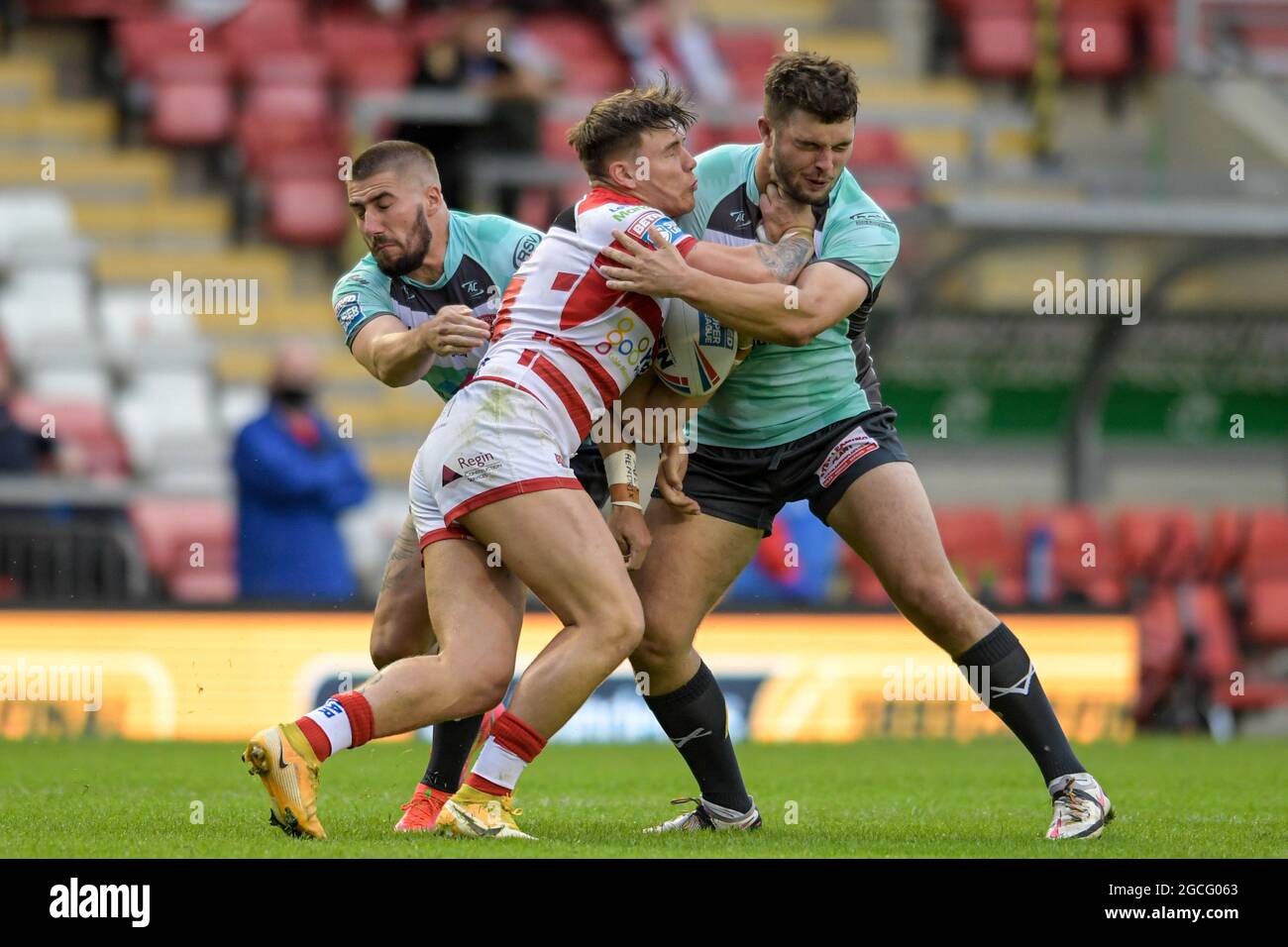 Keanan Brand (24) of Leigh Centurions is tackled by Matty Storton (18) of Hull KR and Greg Minikin (3) of Hull KR Stock Photo