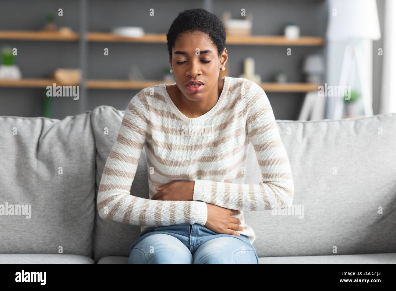 Stomach Ache. Sick Black Female Suffering From Acute Abdominal Pain At