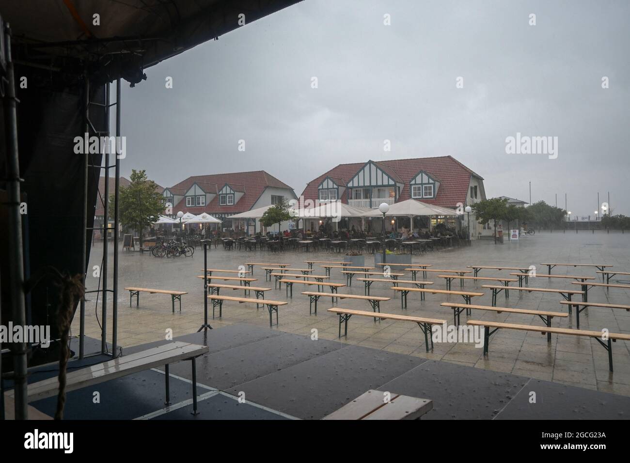 RERIK, GERMANY, 07 August 2021: Empty benches in the rain seen from the stage, canceled theater performance and entertainment in the tourist resort of Stock Photo