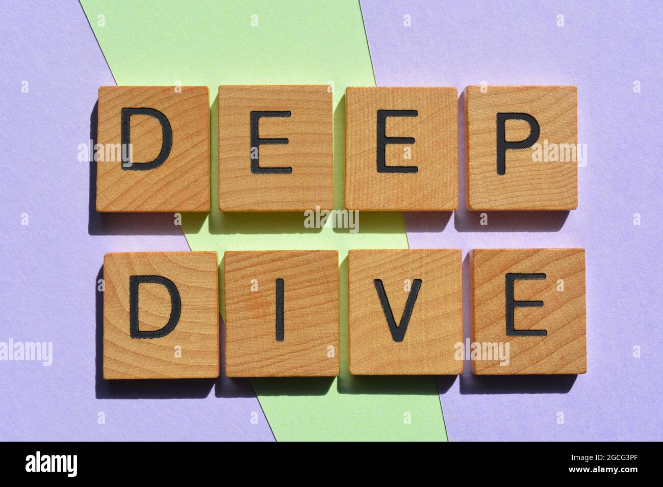 Deep Dive, words in wooden alphabet  letters isolated on background as banner headline Stock Photo