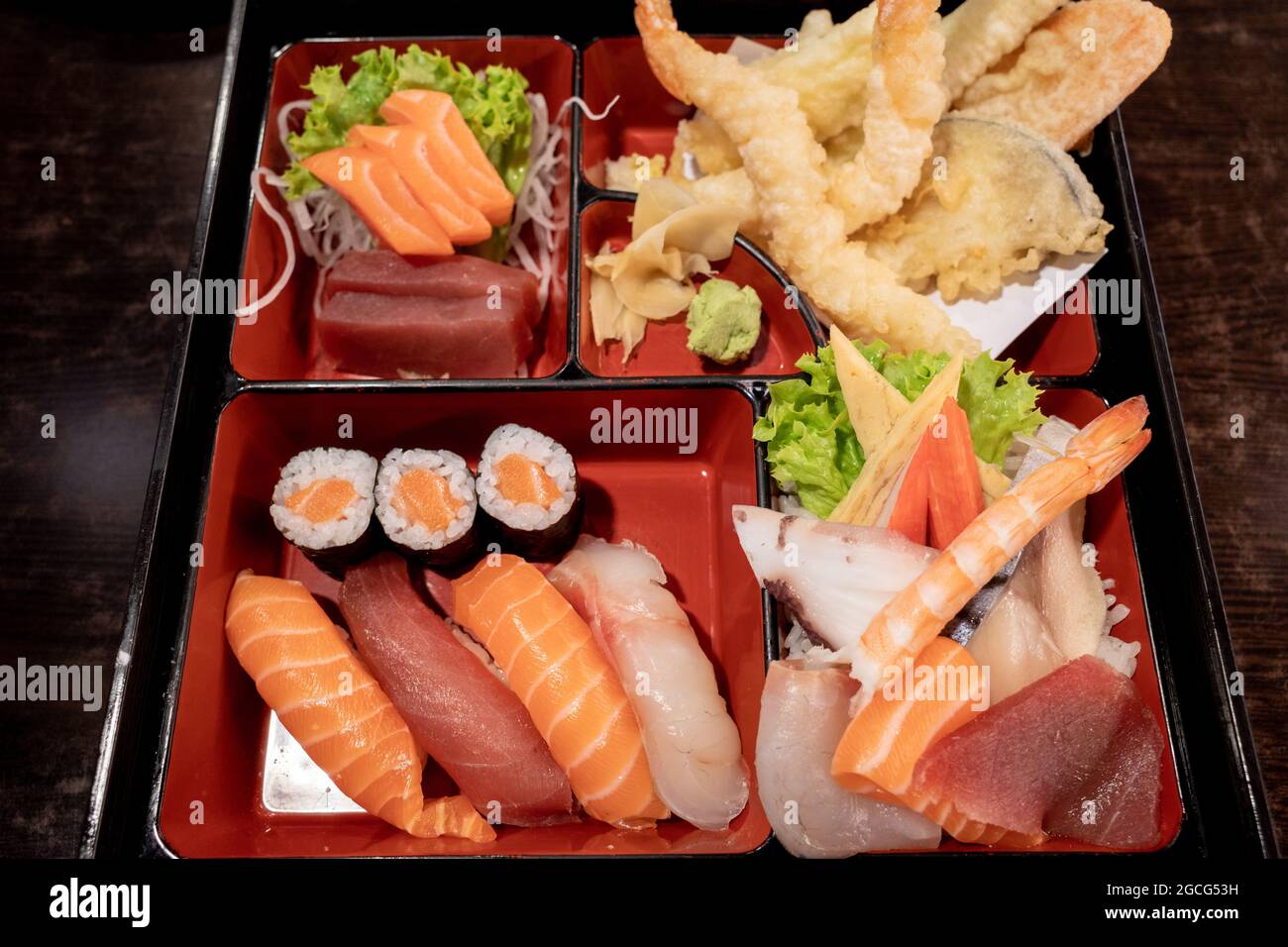 Selective focus and top view at Sushi Bento Box Set, contain salmon and