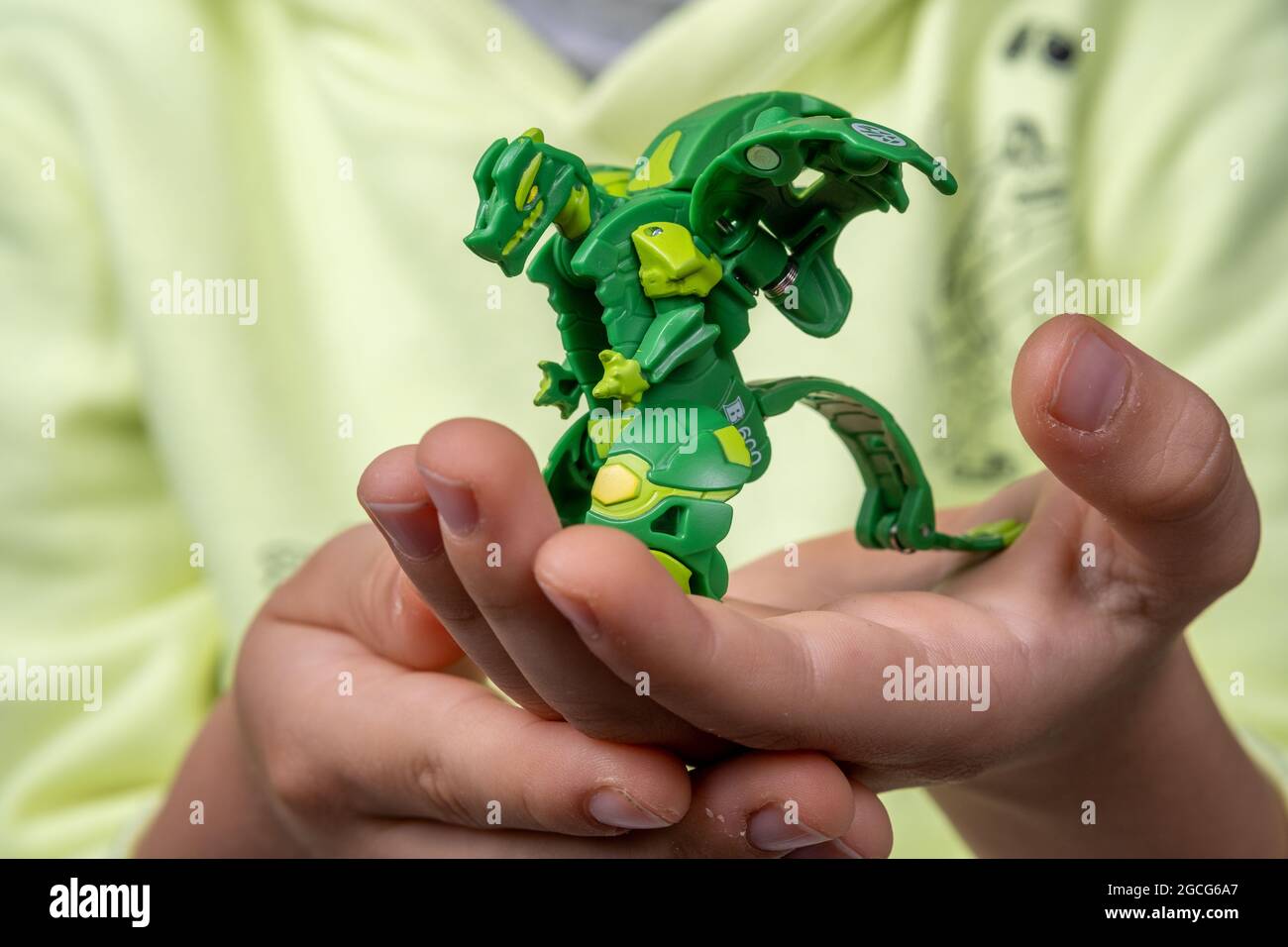 Bakugan Ball toy transformed in dragon and hold in child's hand. Stafford, United Kingdom, August 8, 2021 Stock Photo