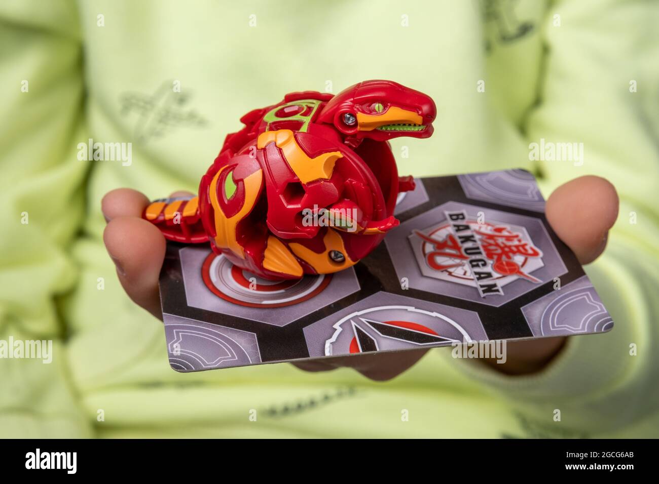 Bakugan Ball toy. Toy transformed in a dragon shape, hold in child's hand with magnetic card. Stafford, United Kingdom, August 8, 2021 Stock Photo