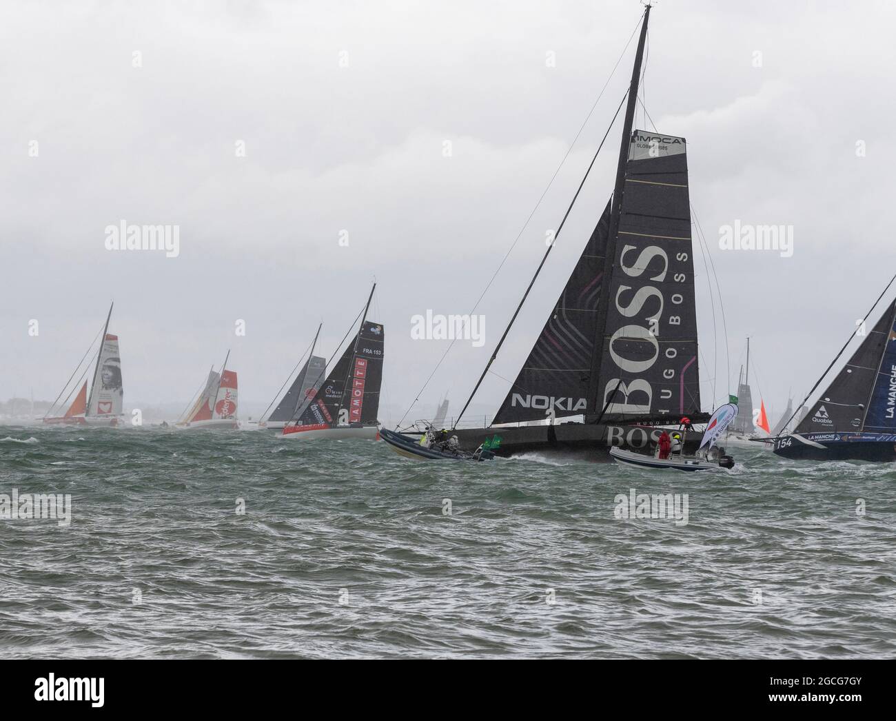 Cowes Isle of Wight, UK. 8th August 2021. Rolex Fastnet; Hugo Boss , IMOCA  60 heading out of the Solent in 35 knots of wind at the start of the Fastnet  Race.