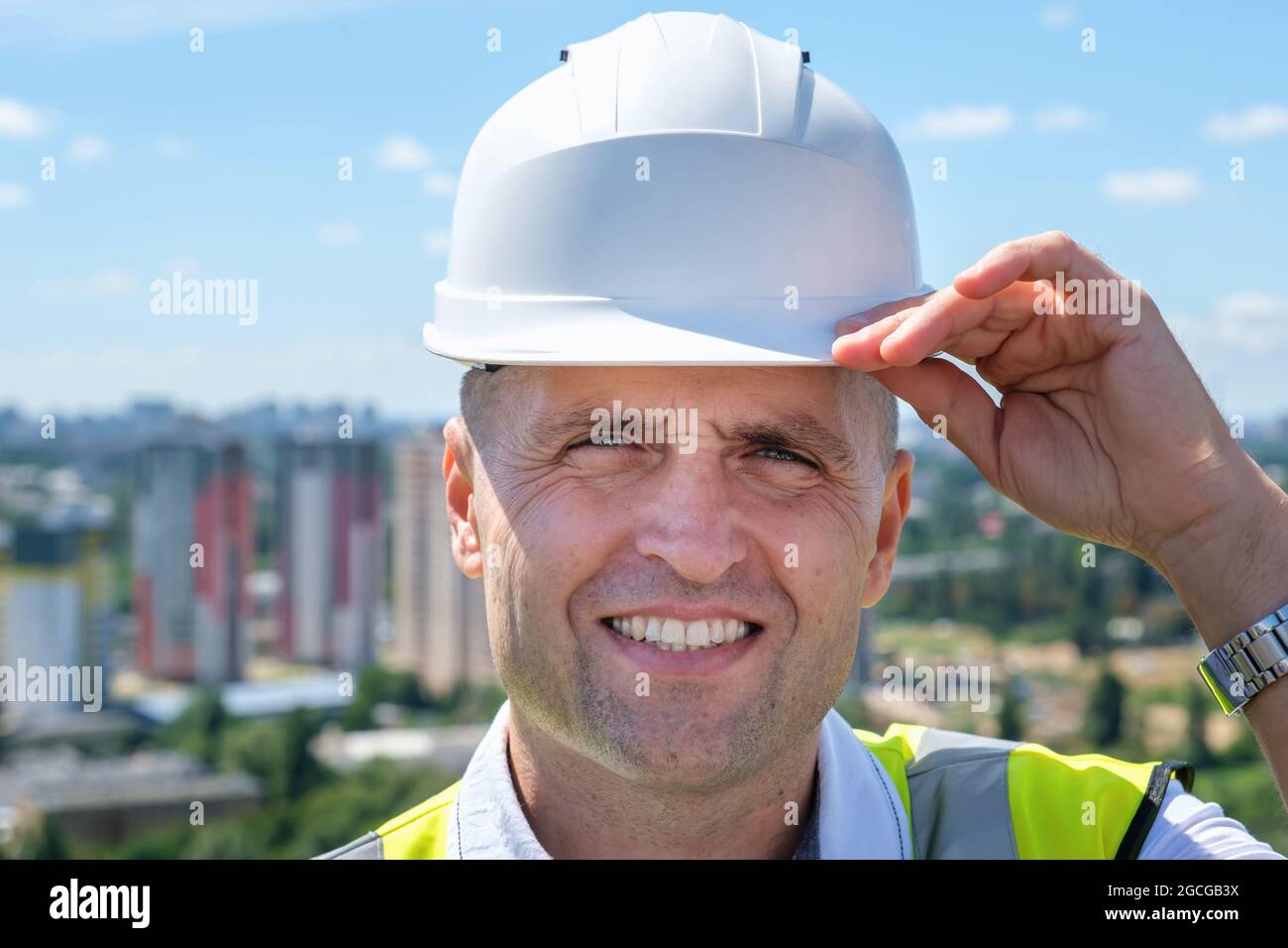 Confident construction engineer in hardhat and with jacket on shoulders Stock Photo
