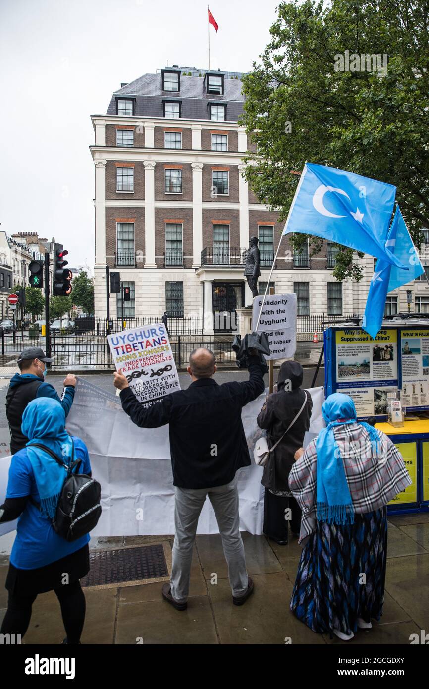 London, UK. 5th August, 2021. Activists from Uyghur Solidarity Campaign UK and other supporting groups hold placards and wave Uyghur flags opposite the Chinese embassy in support of the Uyghur people’s struggle for freedom. Activists highlighted the Chinese government's persecution and forced assimilation of Uyghurs, Kazakhs and other indigenous people in East Turkestan and Xinjiang and called for them to have the right to determine their own futures through a democratic process. Credit: Mark Kerrison/Alamy Live News Stock Photo