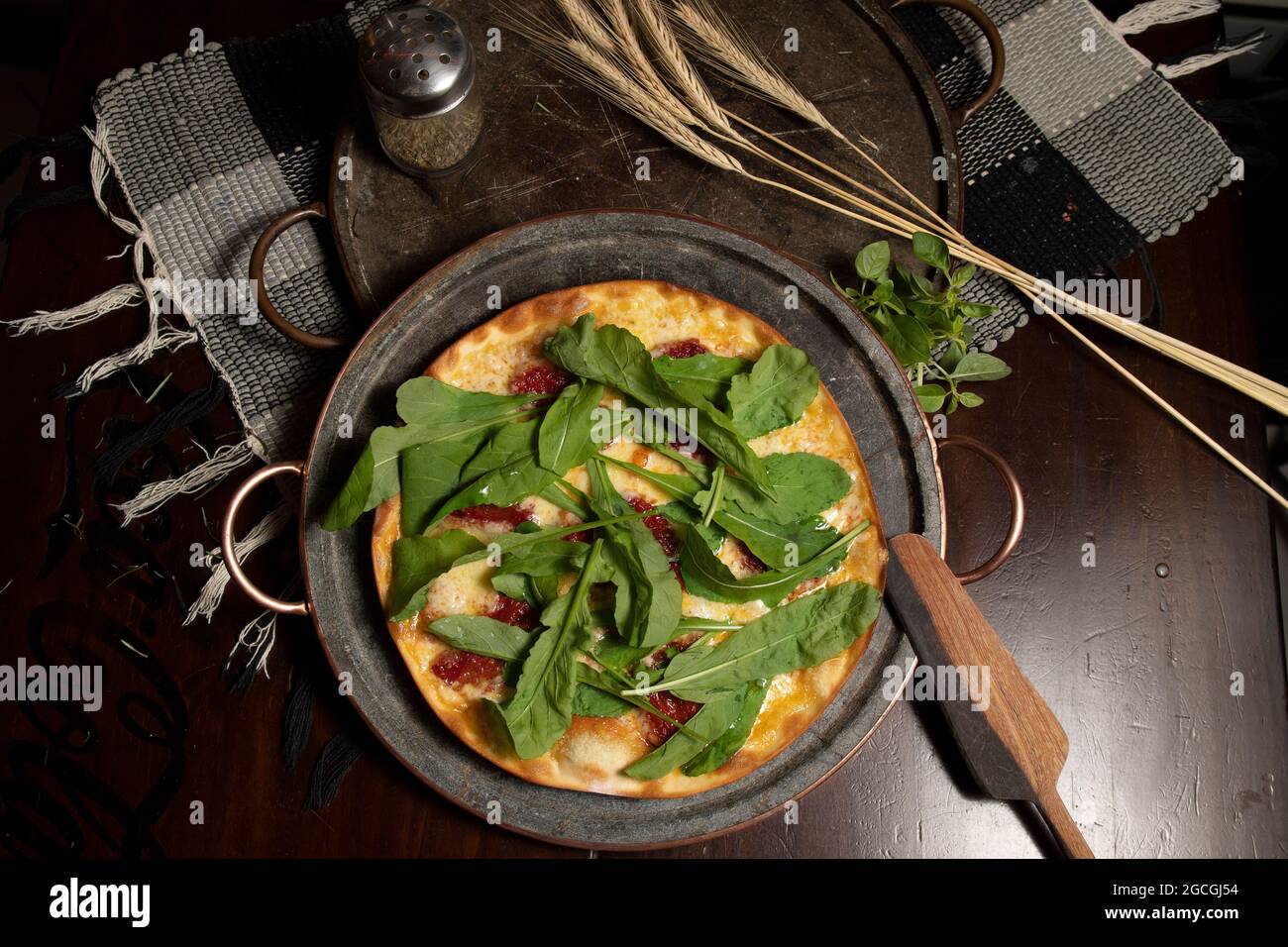 Brazilian pizza with sundried tomatoes, arugula and mozzarella