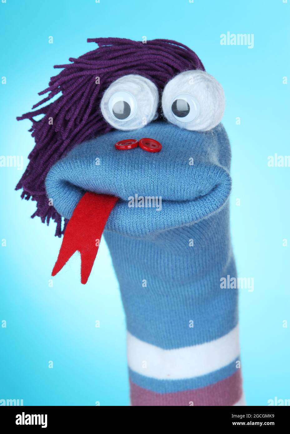 Cute sock puppet on blue background Stock Photo Alamy