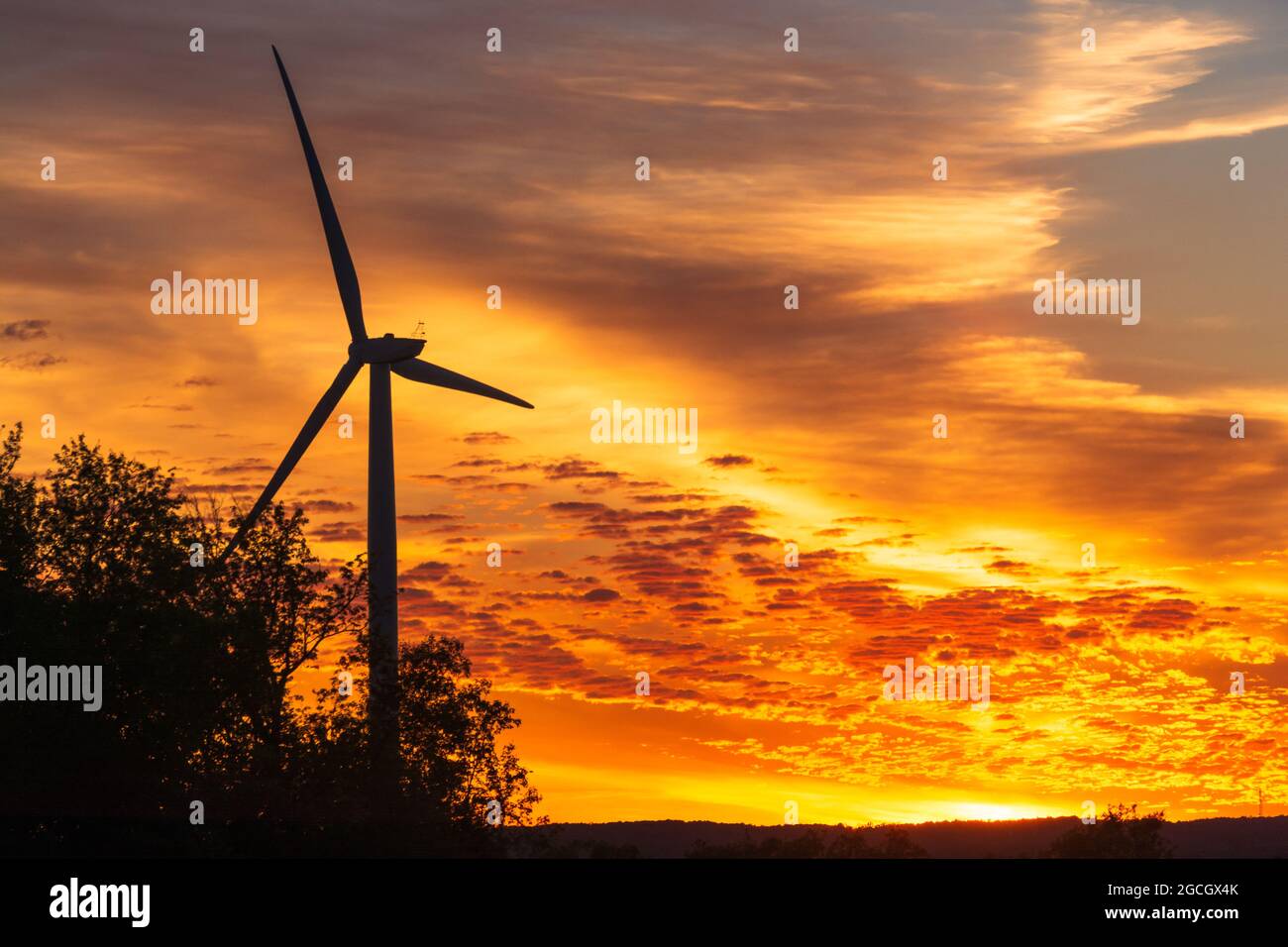 Beautiful exotic sunset sky with wind turbine Stock Photo - Alamy