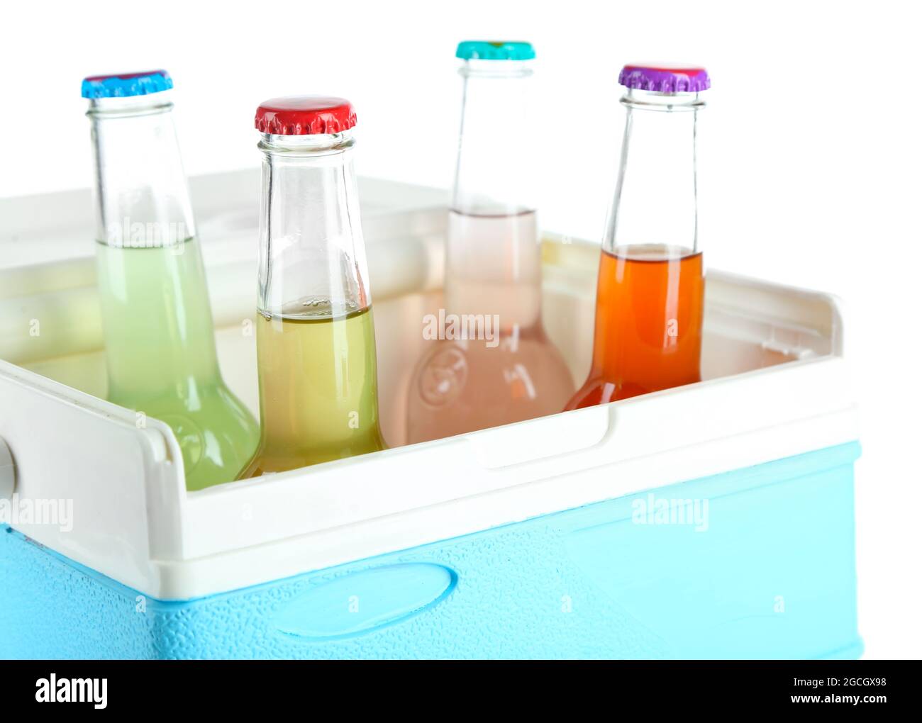 Drinks in glass bottles in mini fridge isolated on white Stock Photo