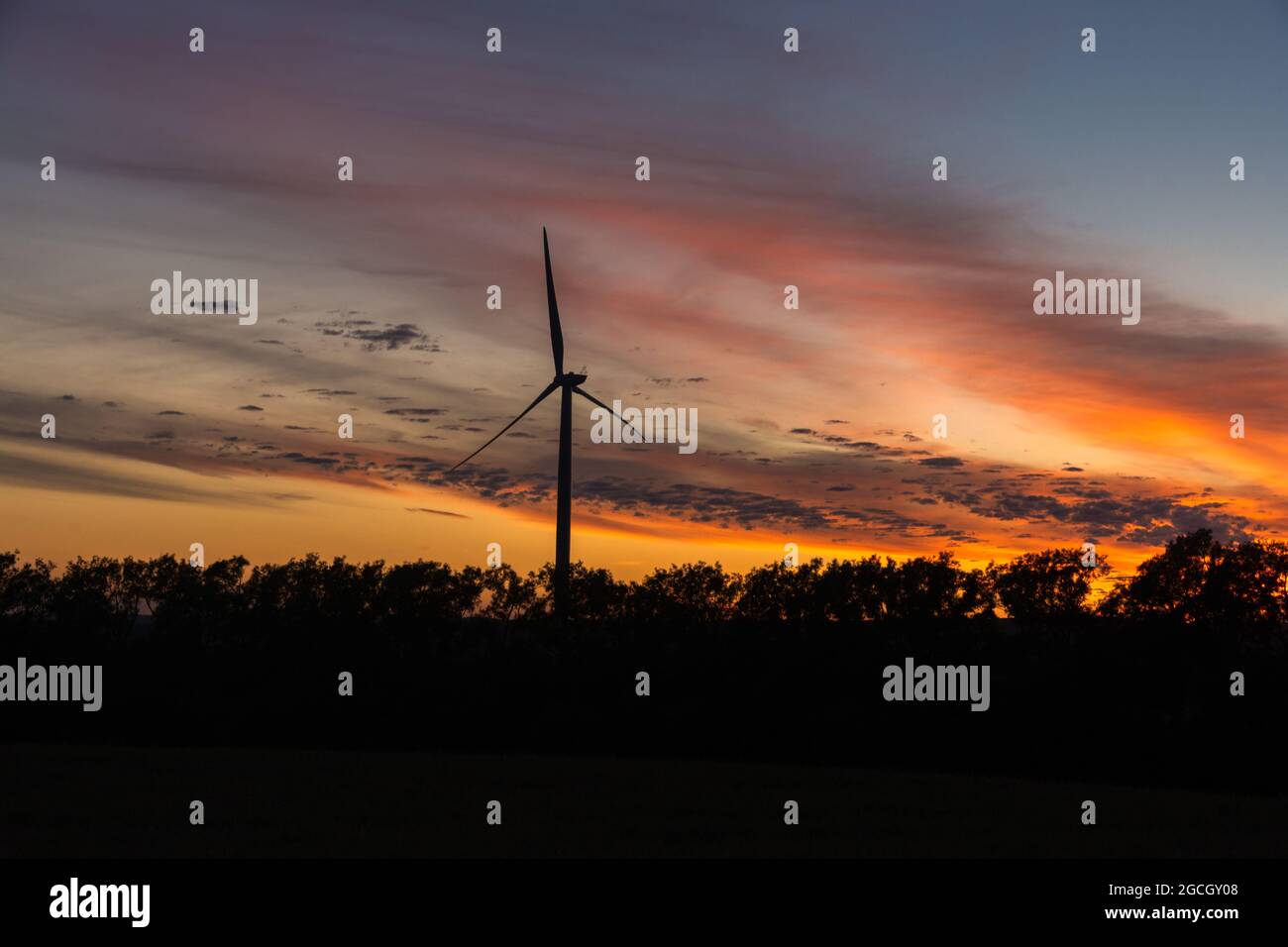 Beautiful exotic sunset sky with wind turbine Stock Photo - Alamy