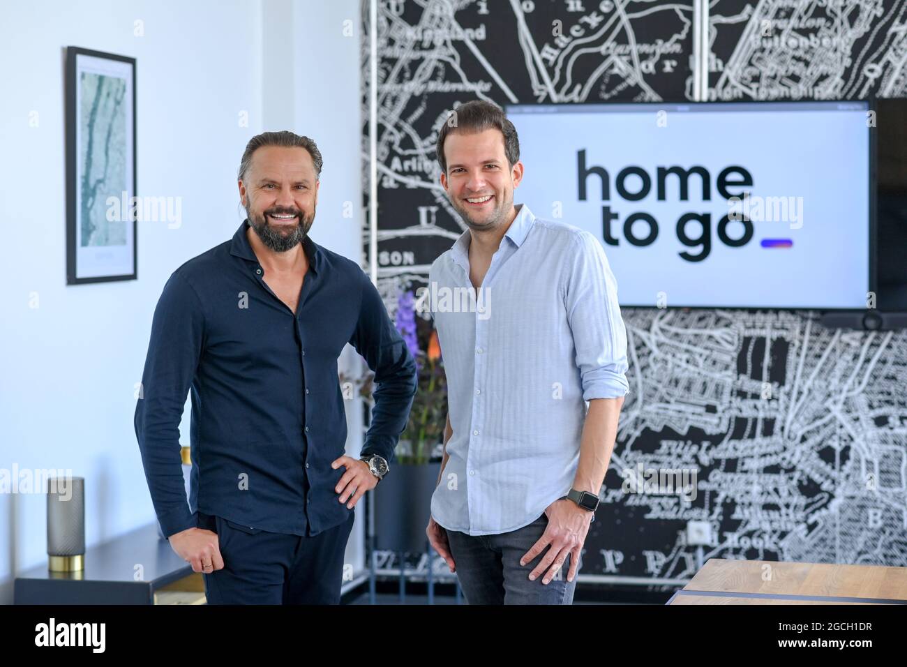 PRODUCTION - 29 July 2021, Berlin: Wolfgang Heigl, Co-Founder and Chief Sales Officer of HomeToGo, and Patrick Andrae, Co-Founder and Managing Director of HomeToGo, during a press event at the company's headquarters in Prenzlauer Berg. HomeToGo is a digital marketplace with what it claims is the world's largest selection of holiday homes and apartments. Founded in 2014, the company currently employs more than 350 people and operates 23 localized apps and websites in Europe, the Americas, Australia and the Asia-Pacific region. Photo: Jens Kalaene/dpa-Zentralbild/ZB Stock Photo