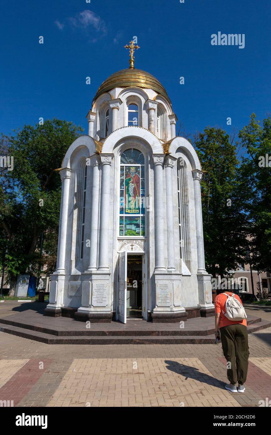 Belgorod, Russia - July 08, 2021: Woman prays before the Saint Prince Vladimir's chapel in Belgorod. Stock Photo