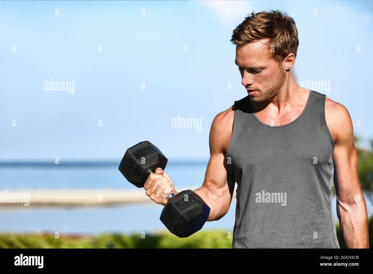 Bicep curl free weights training fitness man outside working out arms  lifting dumbbells doing biceps curls. Fit man arm exercise workout  exercising Stock Photo - Alamy