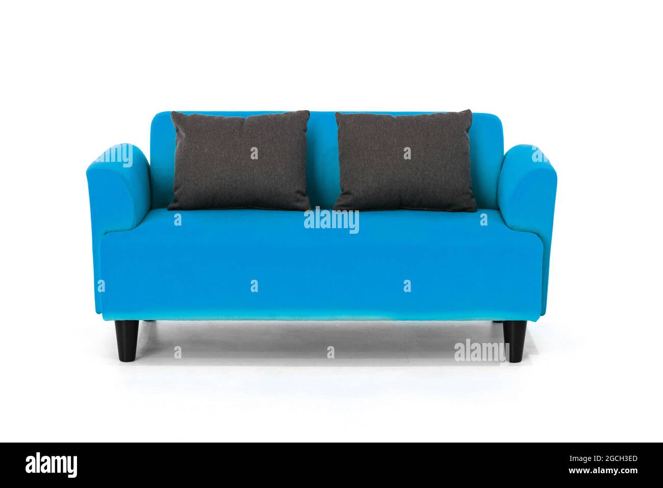 Blue Scandinavian style contemporary sofa on white background with modern and minimal furniture design for stylish living room. Stock Photo