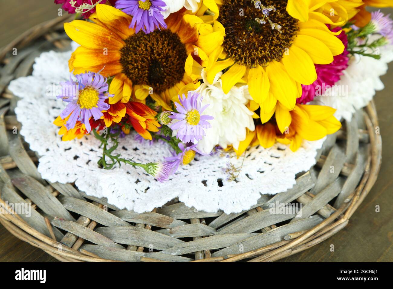 Bouquet of wild flowers on wicker tray on wooden background Stock Photo ...