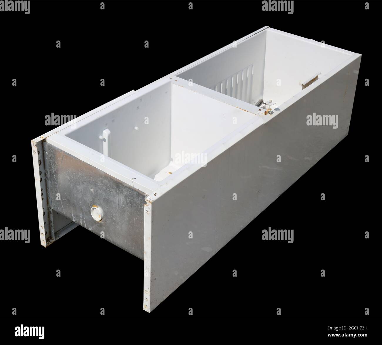 Broken refrigerator in a garbage dump isolated on black Stock Photo