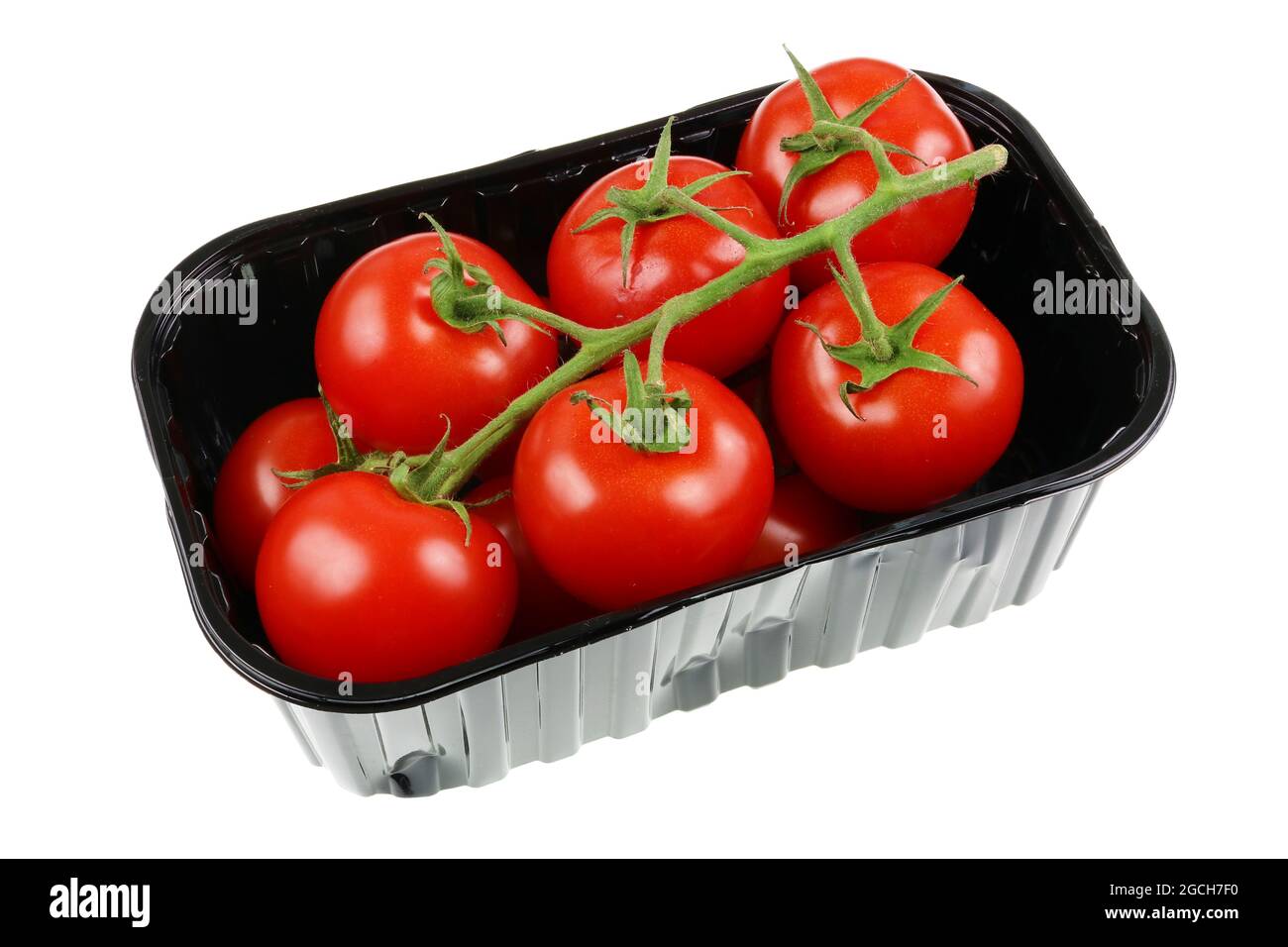 Red ripe eco tomatoes in black plastic box. Isolated on white studio ...