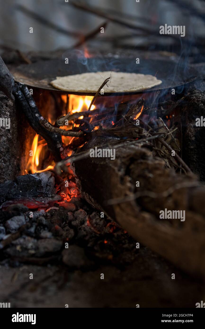Cooking on fire in rural village Stock Photo