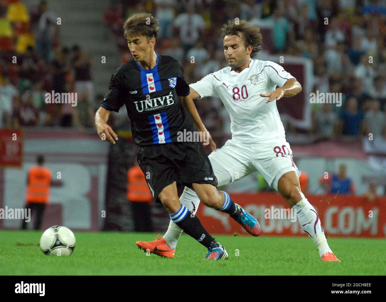 BUCHAREST, ROMANIA - AUGUST 9, 2012: Filip Djuricic (L) of Heerenveen and Filipe Teixeira (R) of Rapid pictured in action during the second leg of the 2012/13 UEFA Europa League Third Qualifying Round game between Rapid Bucuresti and FC Heerenveen at National Arena. Stock Photo