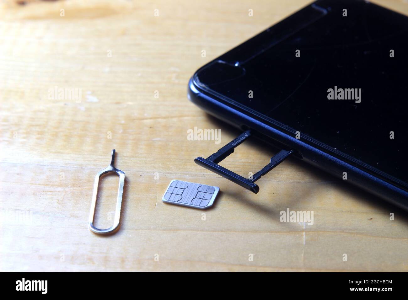 Sim CARD Ejector and Smartphone at Wooden Table Stock Photo Alamy