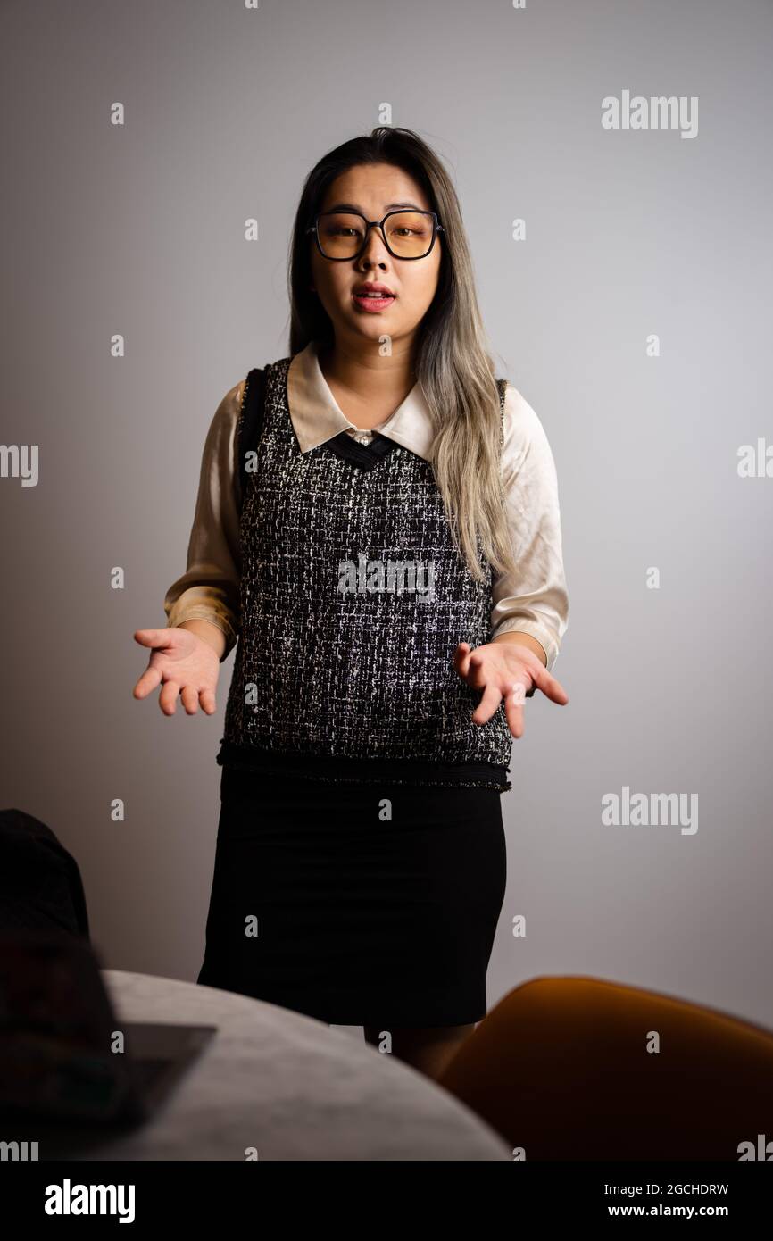 Young Asian Female Data Scientist Presenting Analytics Data in a Conference Room Stock Photo