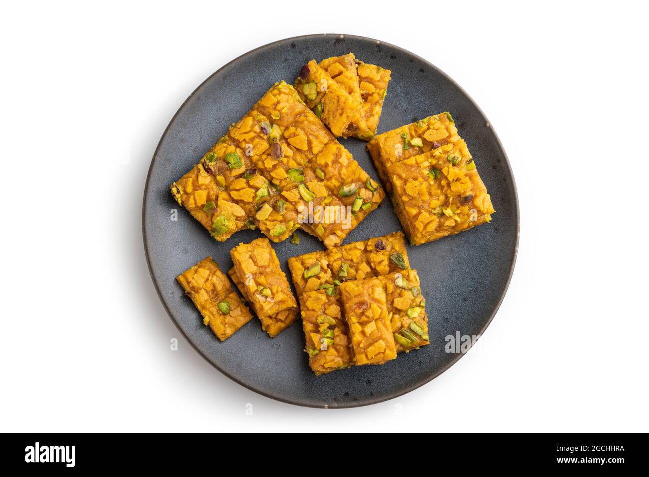 Traditional iranian dessert sohan on blue plate isolated on white ...