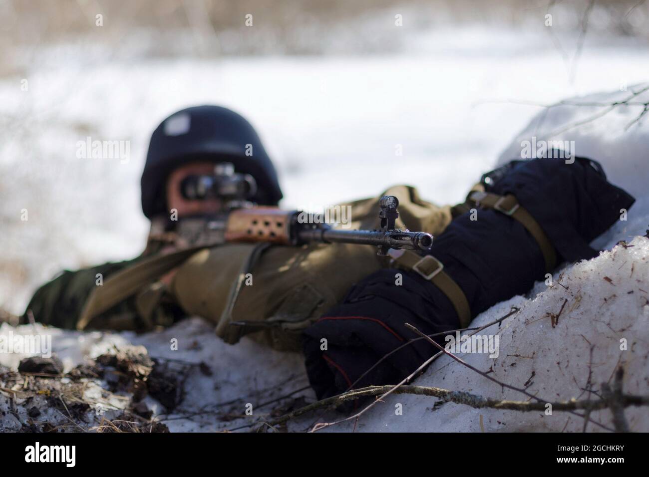 A sniper of the Russian Guard at a firing position during the military exercise.In Elektrostal, a practical lesson was held with servicemen and employees of special forces of the Central District of the Russian Guard. Stock Photo