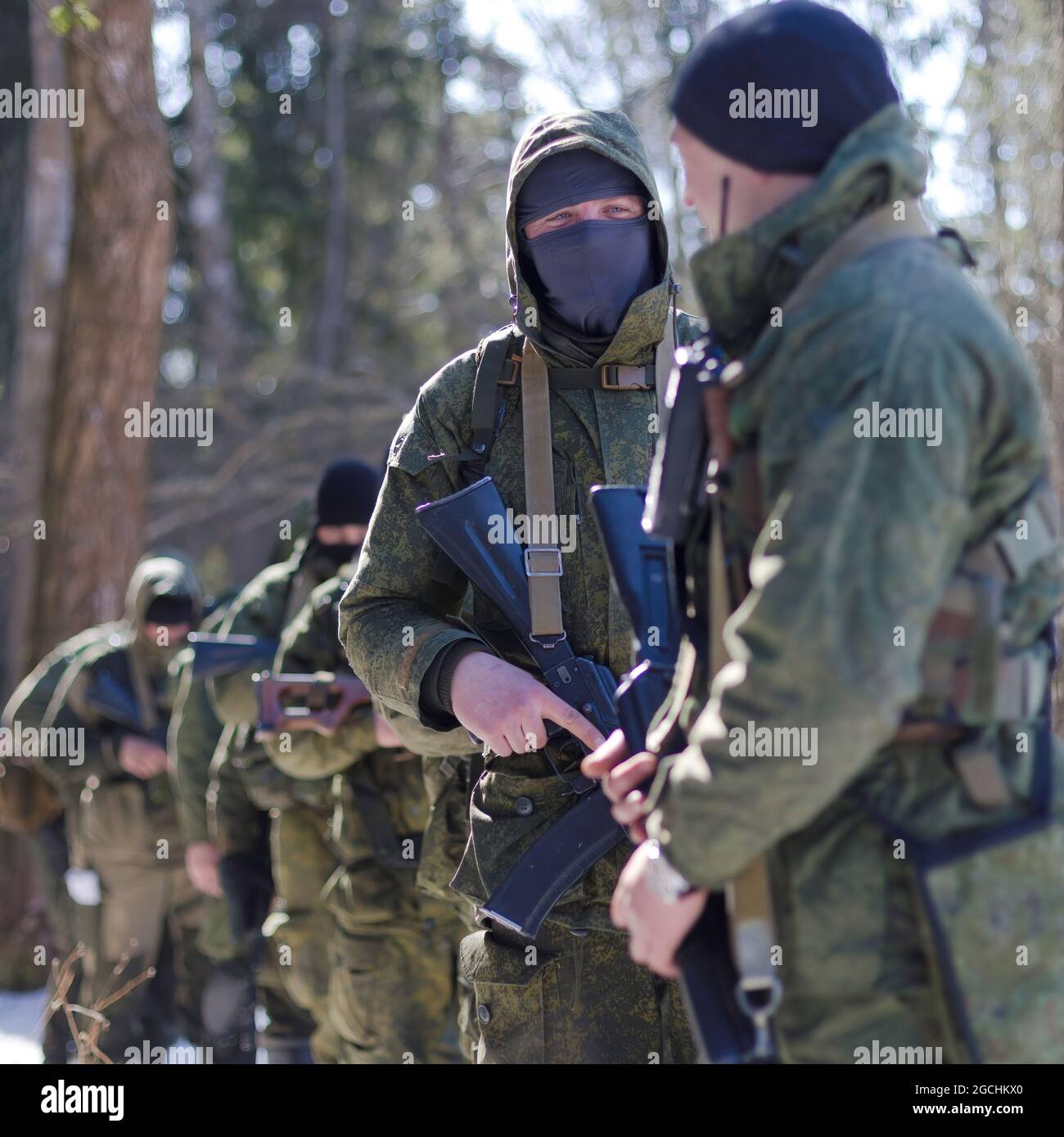 Spetsnaz forces seen coordinating their actions in the forest during the military exercise. In Elektrostal, a practical lesson was held with servicemen and employees of special forces of the Central District of the Russian Guard. Stock Photo