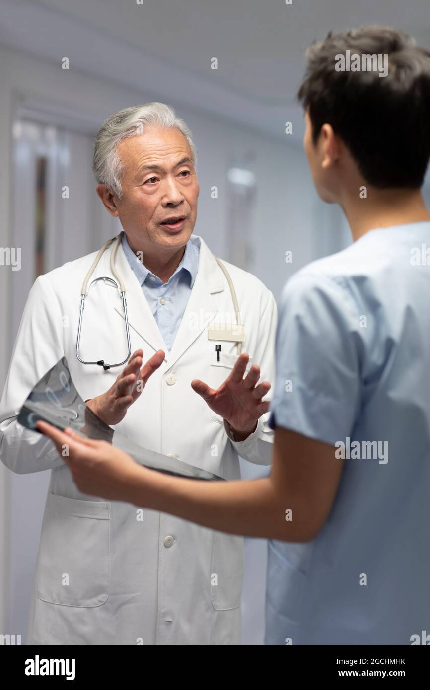 Doctors discussing X-ray image Stock Photo